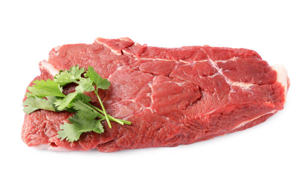 istock Piece of raw beef meat with parsley isolated on white 1824715120