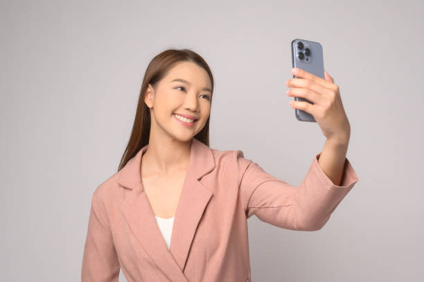 istock Young asian woman using smartphone over white background, technology concept. 1824718615