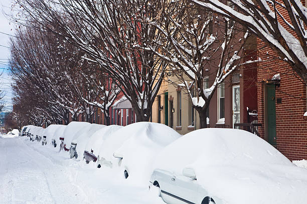 Blizzard City street completely covered in snow. Cars are invisible. philadelphia winter stock pictures, royalty-free photos & images