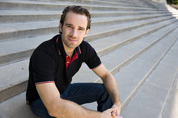 istock Young man sitting on stairs 182472266
