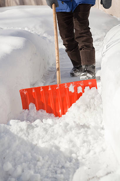 istock Winter Blizzard Storm Snow on Sidewalk Removal by Snow Shovel 182472344