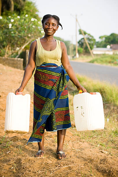 istock African Woman Carrying Water Jugs 182472545