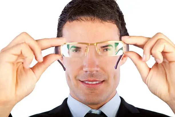 Businessman looking through his glasses.