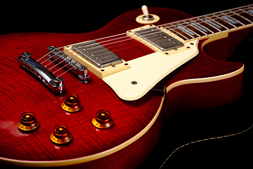 Red six-string electric guitar. Electric guitar close-up.