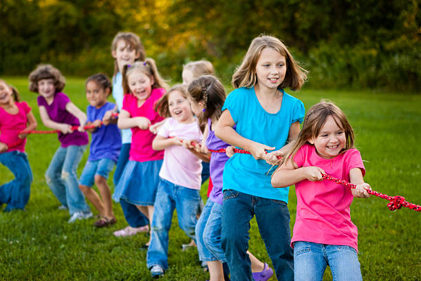 istock Girls Playing Tug-of-War Game Outside 182472811