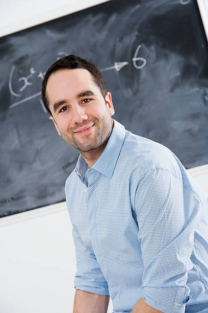 istock Student or Teacher in Front of School Chalkboard 182472857