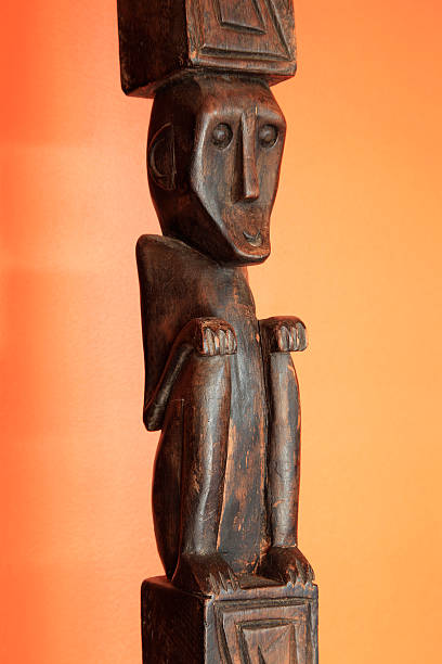 istock Wooden Tribal Statue on orange background 182473047