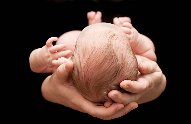 istock Newborn held in mother's hands 182473134