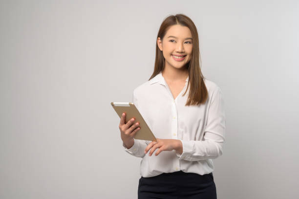 istock Young asian woman using tablet over white background, technology concept. 1824731429