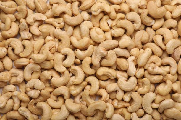 istock Many tasty cashew nuts as background, top view 1824735690