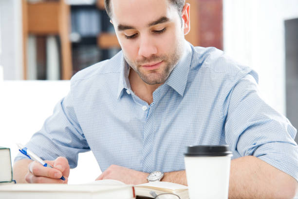 istock Low depth photo of a man working at his desk with coffee 182474562