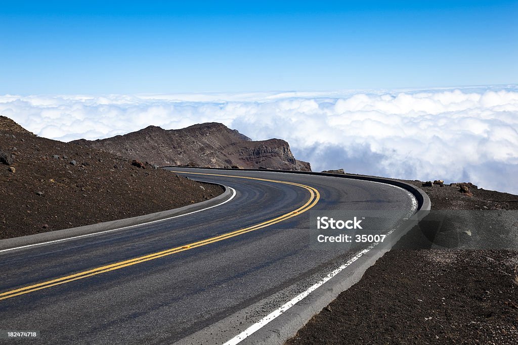 the road at haleakala volcano, maui, hawaii, USA. "a winding road seems to lead to the sky. road to haleakala volcano, maui, hawaii, USA." Winding Road Stock Photo