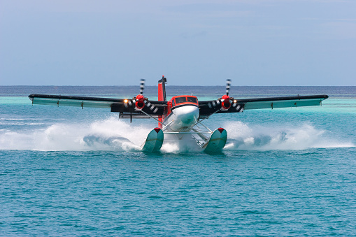Twin Motor Passenger Seaplane Landing in Calm Lagoon Waters - Republic of Maldives - Indian Ocean