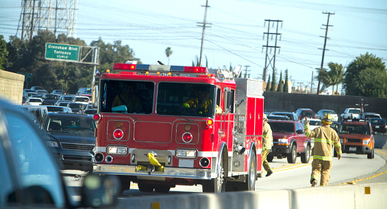 A fire truck at a car accident on a California freeway.