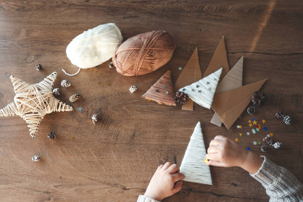 istock Child makes Christmas decoration from yarn 1824753882