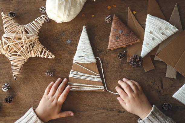 istock Child makes Christmas decoration from yarn 1824753891