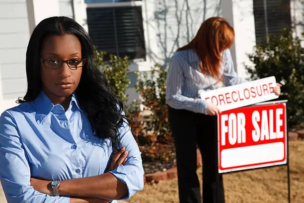 Photo of Upset Woman Outside Home Being Foreclosed On