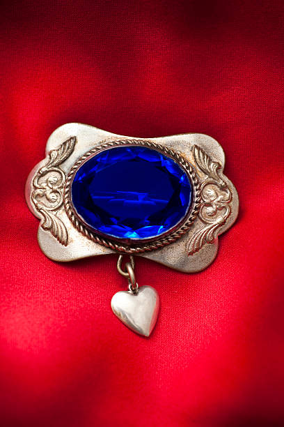 istock Closeup of old brooch with blue gem and heart 182476310