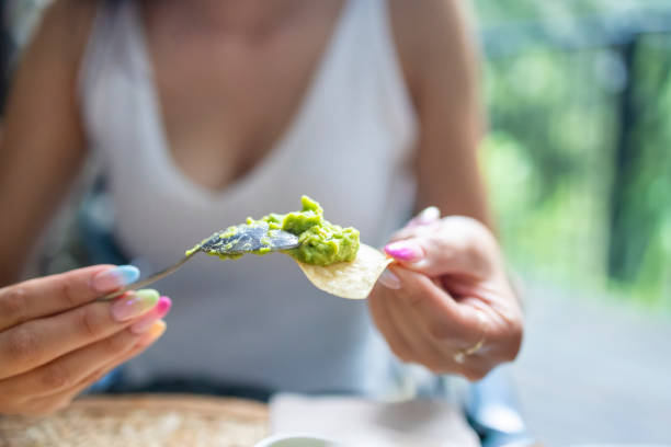 Serving delicious guacamole on a tortilla chip