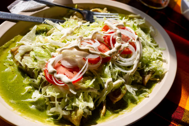 istock Green enchiladas with lettuce and tomato dish 1824764411