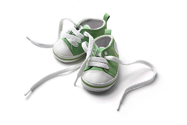 Shoes: Green Baby Shoe More photos like this here... baby booties stock pictures, royalty-free photos & images