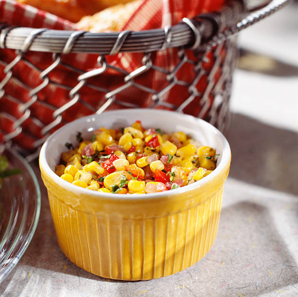 Corn salad in yellow bowl Bowl of corn salad close-up corn salad stock pictures, royalty-free photos & images