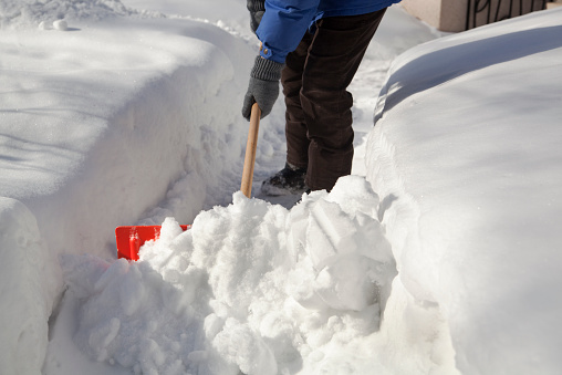 Subject: Shoveling snow from the street sidewalk after the winter blizzard.