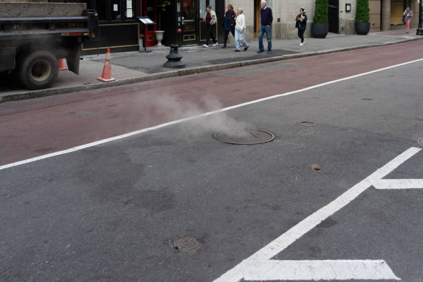 hot steam from a road manhole. asphalt