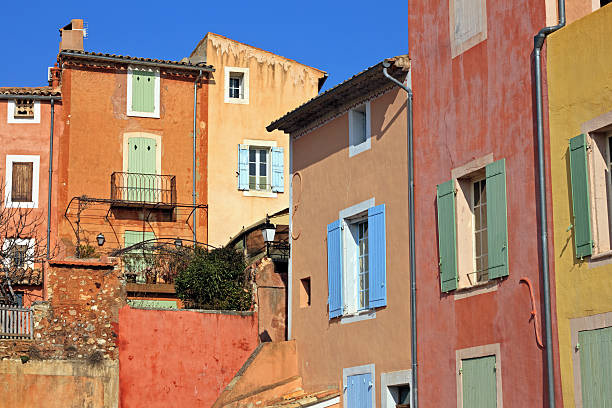 Roussillon: A narrow street in the beautiful French village of Roussillon, where the buildings are made with colorful, locally mined ochre. France