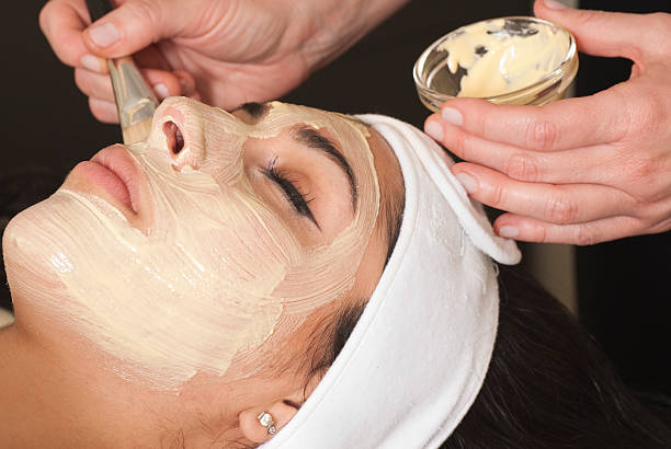 Woman Getting A Facial "Woman having facial mask applied.Click below for a lightbox of others in this series, plus all my spa and beauty treatment images:" Esthetician stock pictures, royalty-free photos & images