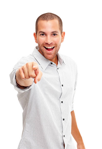 Happy handsome guy pointing at you against white