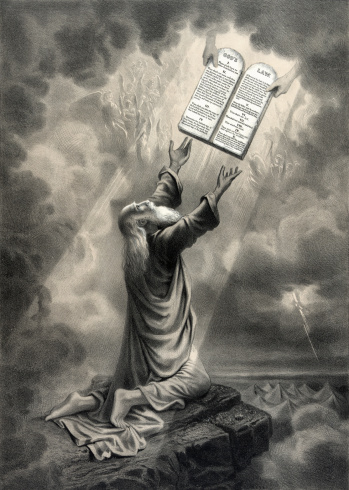 An vintage engraving featuring Moses receiving the Ten Commandments.