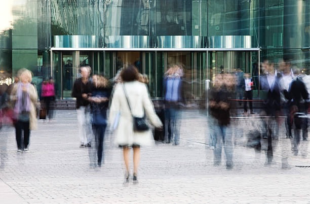 business persone entrare e lasciare l'ufficio edificio attraverso le porte girevoli - urgency speed construction walking foto e immagini stock