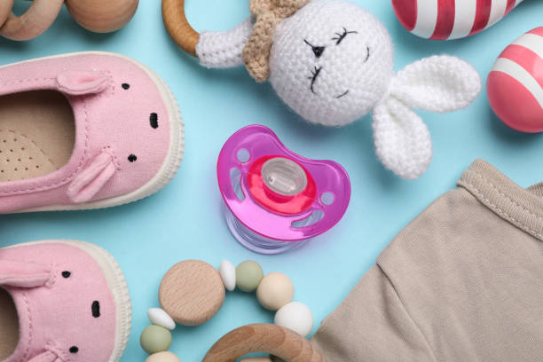 istock Flat lay composition with pacifier and other baby stuff on light blue background 1824782139