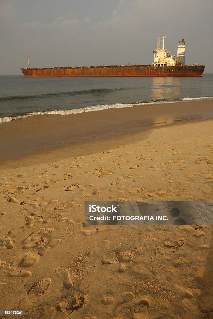 Beach in Candolim "Early morning beach scene in town of Candolim, province of Goa (India).Arabic sea view with old ship wreck now famous all over the world..." Anjuna Stock Photo