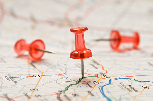istock Close-up of a Red pushpin stuck into a map 182478483