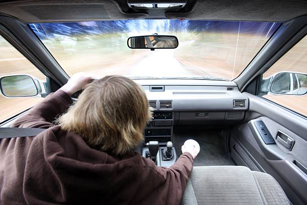 istock Distracted Teen Driver - Picking Up CD Off The Floor 182478620