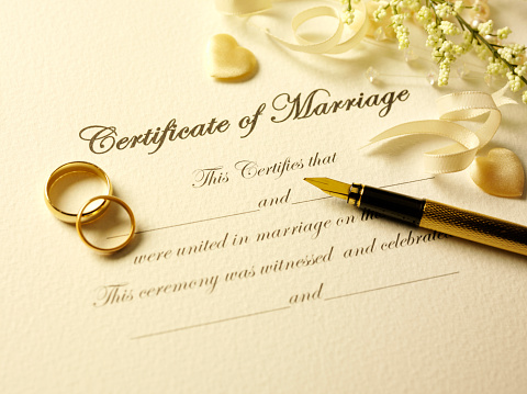 Certificate of marriage with a pen and gold rings.Click on the link below to see more of my wedding and party image.