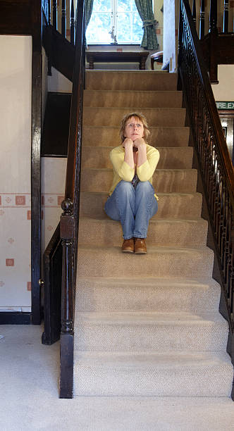 istock Pensive mature woman on the staircase 182479197