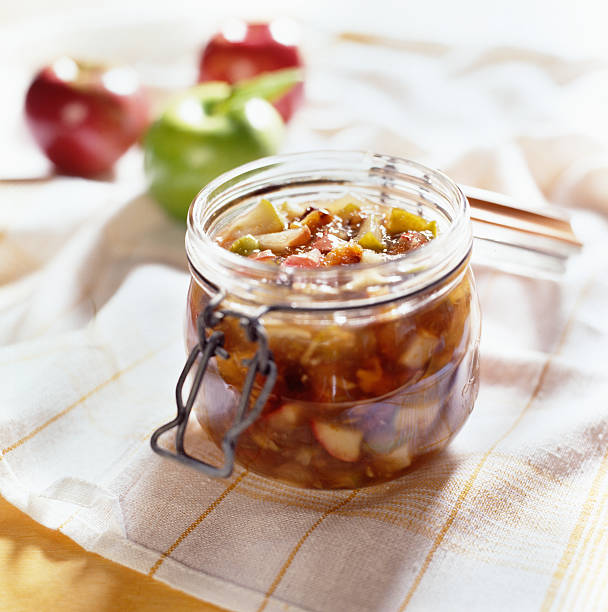 Apples preserved in open mason jar. stock photo