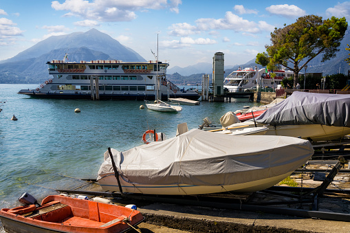 Malcesine, Italy - July 20, 2019: Boats parked in small harbor in Malcesine, Italy located at lake Garda during hot summer day in 2019