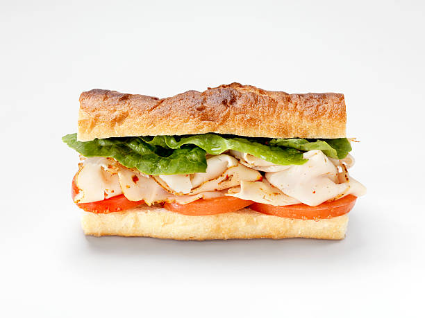 Turkey Sandwich on a Baguette Turkey Sandwich on a Baguette with Lettuce and Tomato -Photographed on Hasselblad H3D2-39mb Camera submarine sandwich photos stock pictures, royalty-free photos & images