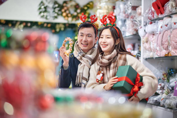 istock Asia Couple Choosing Christmas Present 1824797709