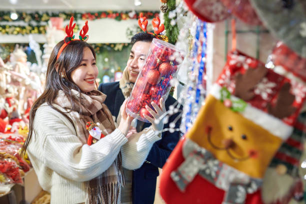 istock Asia Couple Choosing Christmas Balls 1824798566