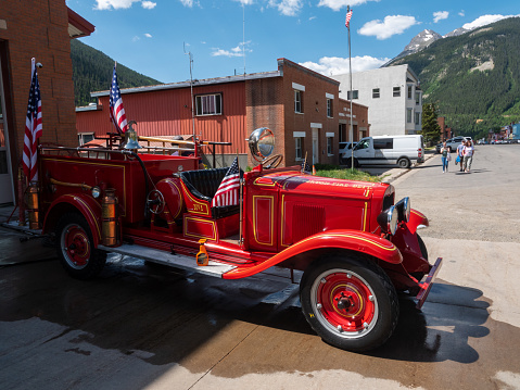 Silverton, Colorado, USA- June 30, 2023:Antique fire engine with flags in preparation for the upcoming 4th of July celebrations.
