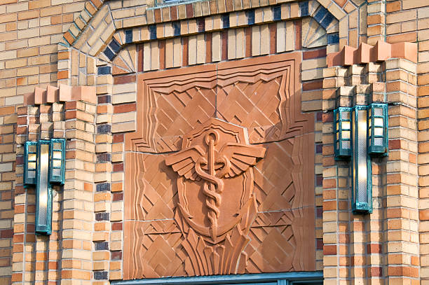 Art deco caduceus and lights on disused medical building