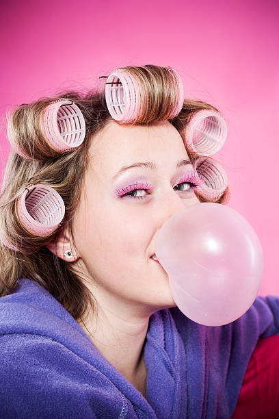 istock Woman with curlers and bubble gum 182479916