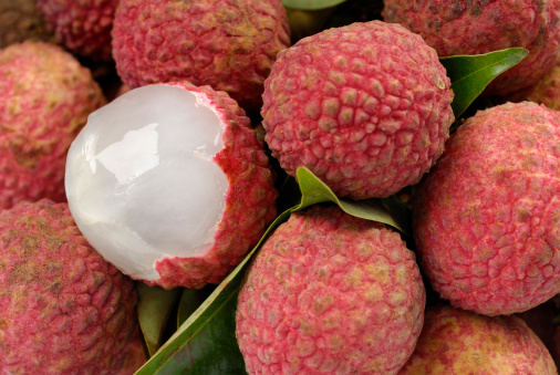 Tasty lychee in bowl on wooden table