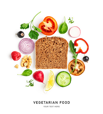 Vegetarian sandwich bread slice and vegetables isolated on white background. Healthy eating and dieting food concept. Tomato, cucumber, pepper, onion, radish, lemon composition. Flat lay, top view