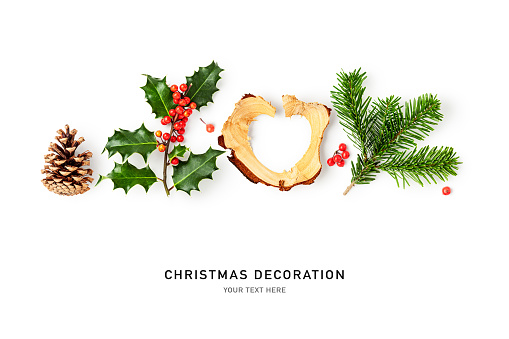 Holly leaves red berry, fir branch, wood shaving heart shaped and cone border isolated on white background. Christmas decoration. Creative layout. Design element. Flat lay, top view